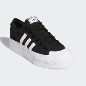 Adidas, women’s  size 8 1/2. Worn a couple of times. Too big for me.